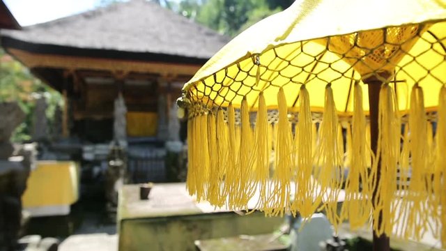 Traditions umbrella on the island of Bali Indonesia. Yellow Traditions Umbrella in Gunung Kawi Is An 11Th Century Temple Complex In Tampaksiring North East Of Ubud, Bali Indonesia
