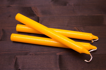 Orange candles on a dark wood table