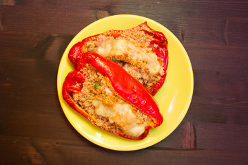 Peppers stuffed with cheese on a wooden table seen from above