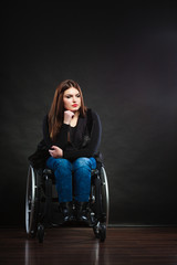 Obraz na płótnie Canvas Sad girl sitting on wheelchair.