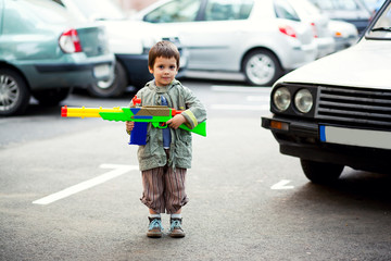 Boy holding toy rifle