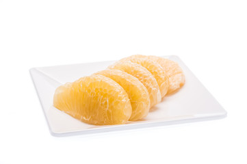 Fresh fruit, slice pomelo on dish on white background.