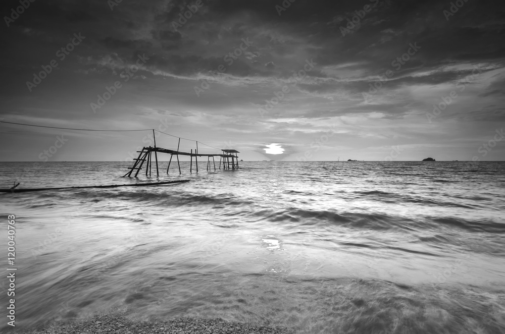 Wall mural silhouette of fisherman jetty during in black in white.