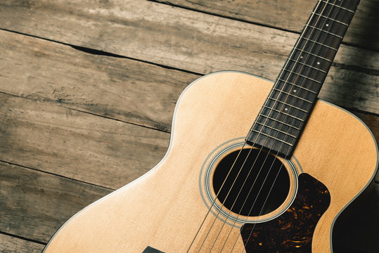 Acoustic guitar on vintage wooden background