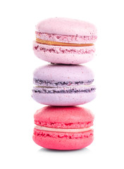 Tower of colorful tasty macaroons on white background