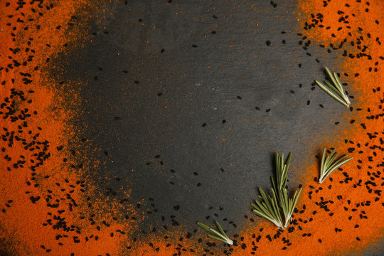 Scattered spices on dark background
