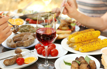 Glass of red wine on picnic table