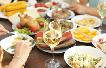 Glass of white wine on picnic table