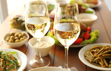 Glasses of white wine on wooden table