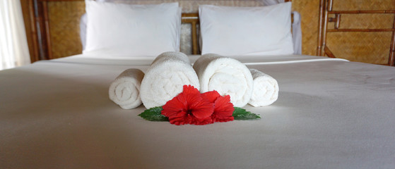 White rolled towel on the bed