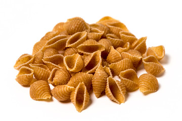 Whole wheat pasta shells isolated on white