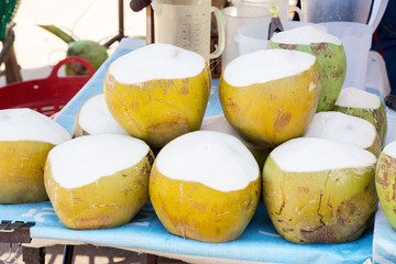 Naklejka na ściany i meble coconuts for sale in a roadside shop in Thailand.Soft focus.