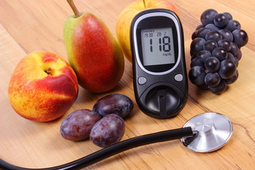 Glucose meter with medical stethoscope and fresh fruits, healthy lifestyle