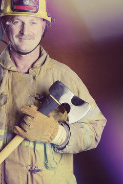 Smiling Firefighter Holding Axe