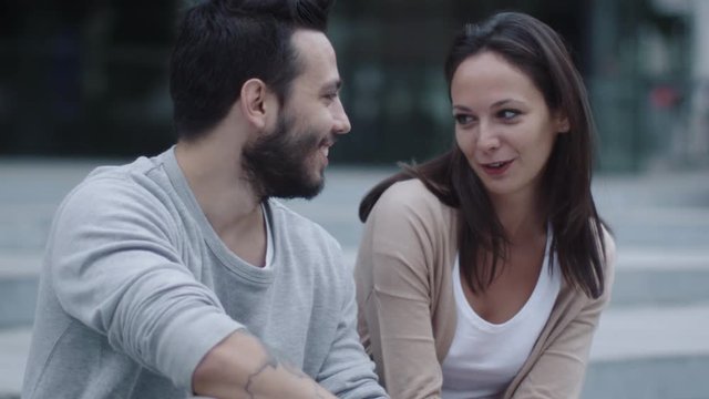 Young Happy Smiling Man and Woman are Communicating Outdoors. Slow Motion Shot. Shot on RED Cinema Camera in 4K (UHD).