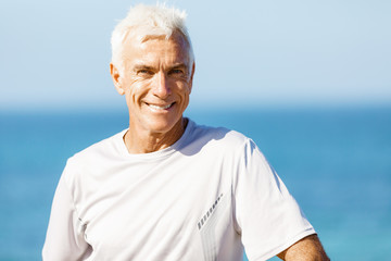 Man standing on beach in sports wear