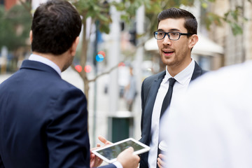 Two businessmen talking outdoors