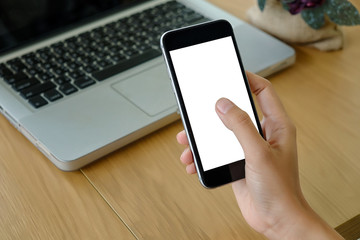 Young woman using smartphone.Beautiful hand holding with blank screen smartphone in cafe.Business concept.Close up.