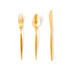 golden fork, spoon, knife isolated on white. flat lay, top view