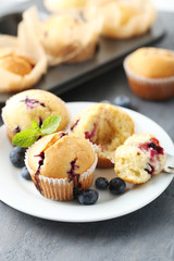 Muffins with blueberries on a grey table