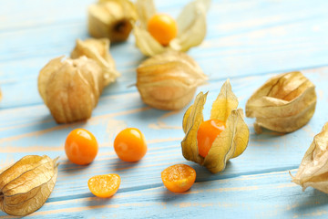Ripe physalis on a blue wooden table