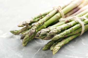 Fresh green asparagus on a grey table