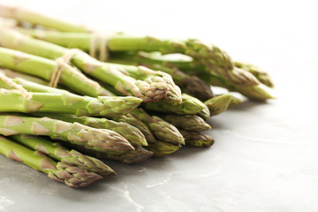 Fresh green asparagus on a grey table
