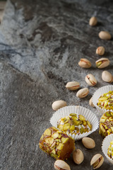 Fototapeta na wymiar Eastern sweets. Turkish delight with pistachios in a vase. Dark