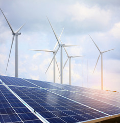 solar panels and wind turbines with the clouds and sky
