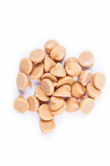 Peanut butter baking chips isolated on white background