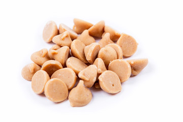 Peanut butter baking chips isolated on white background
