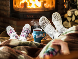 Warming and relaxing near fireplace. Mother and daughter holding © volff