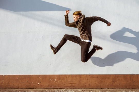 man closeup jump white wall