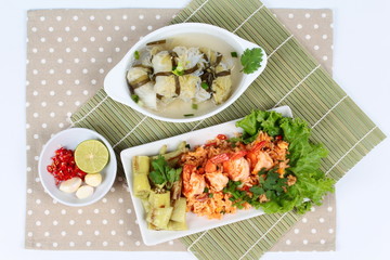 Fried rice with shrimp and grilled green sweet chili served with Streamed lettuce wrap minced pork soup on bamboo. 