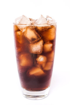 Cola in a glass with dancing bubbles on ice cubes isolated on white background