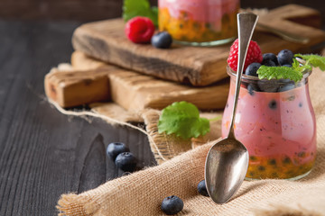 Fresh homemade yogurt in a glass jar with blueberries, raspberri