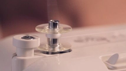 Macro shot of sewing machine - spinning a bobbin