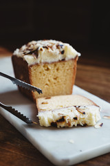 Tongs ready to serve a piece of delicious almond cake