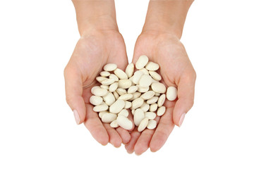 Haricot  beans in woman hand isolated on white background.