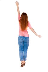 Back view of beautiful woman welcomes. Young teenager girl in jeans hand waving from. Rear view  people collection.  backside view of person.  Isolated over white background.