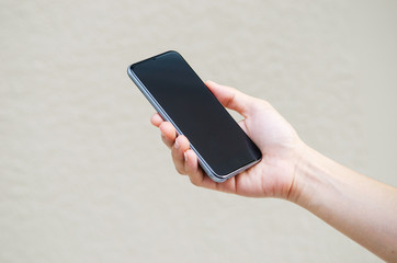 Close up hand holding black phone.