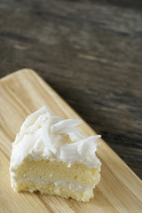 Coconut cake slice on wood plate