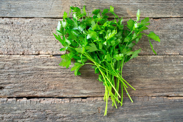 bunch of parsley on wooden surface
