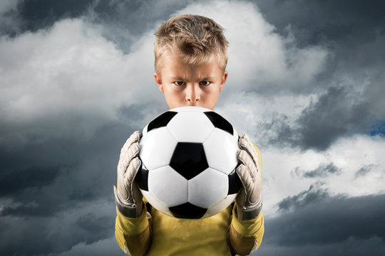 Aspiring young kid posing as a goal keeper.