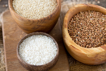 rice, quinoa and buckwheat on wooden surface