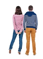 Back view of young couple man and woman hug and look into the distance. beautiful friendly girl and guy together. Rear view. Isolated over white background. young woman holds the hand of her husband