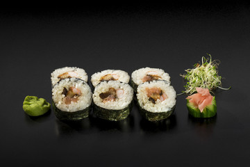 delicious small set sushi rolls decorated with seaweed salad and
