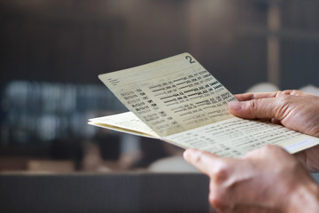 hands holding saving account passbook, book bank on a bank office