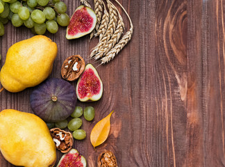 Autumn fruits on wooden background