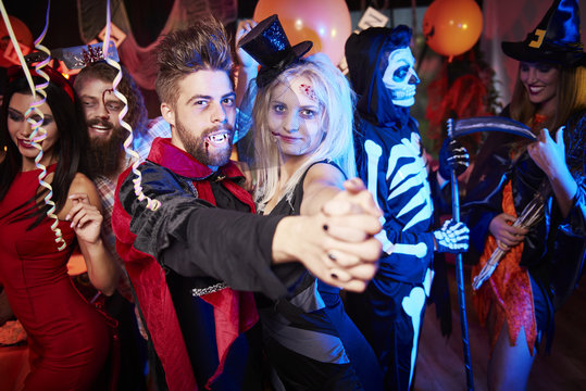 People dancing at halloween party.